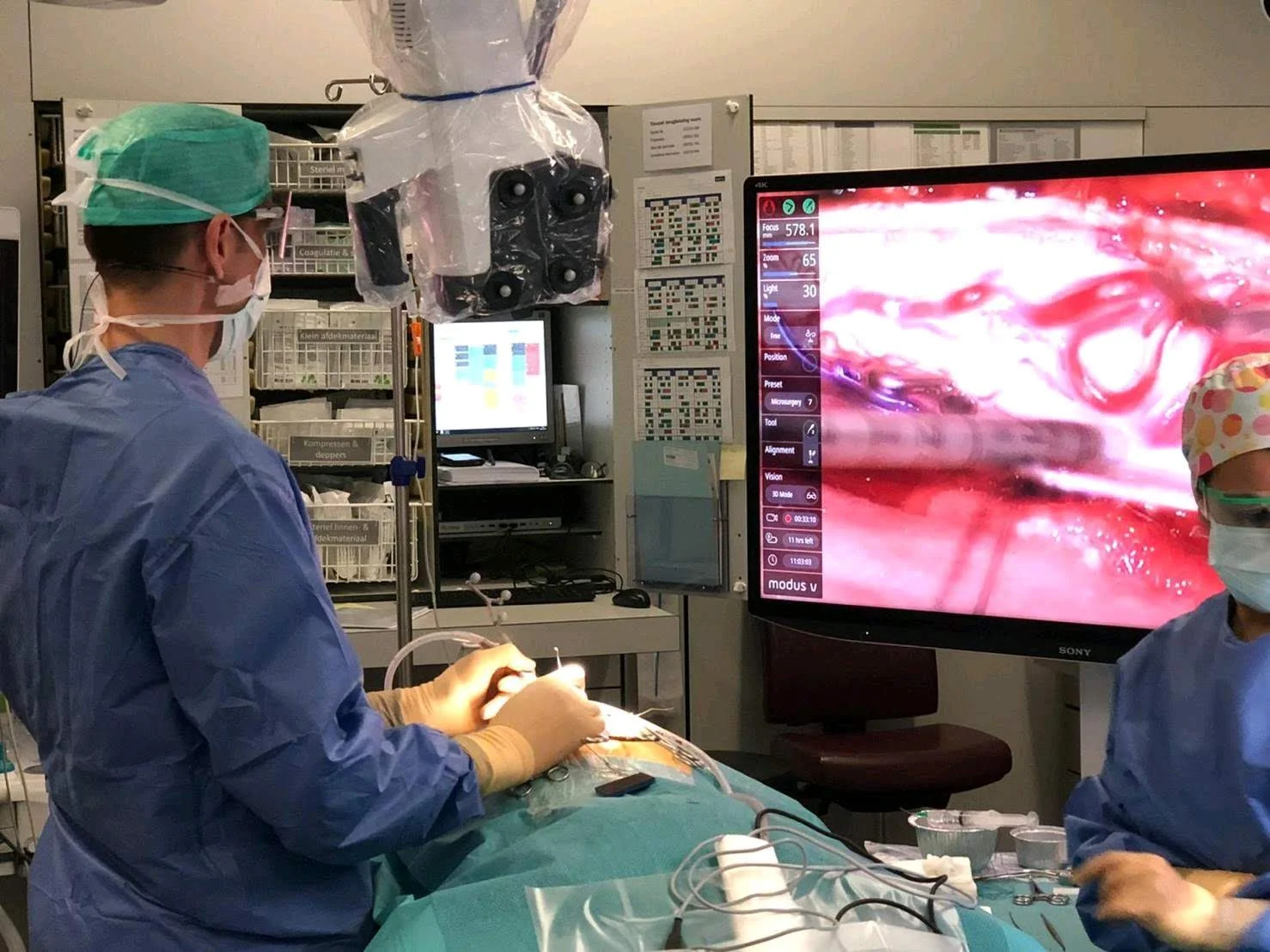 A neurosurgeon working from the redesigned Modus X 10-foot overlay on a 4K display during surgery